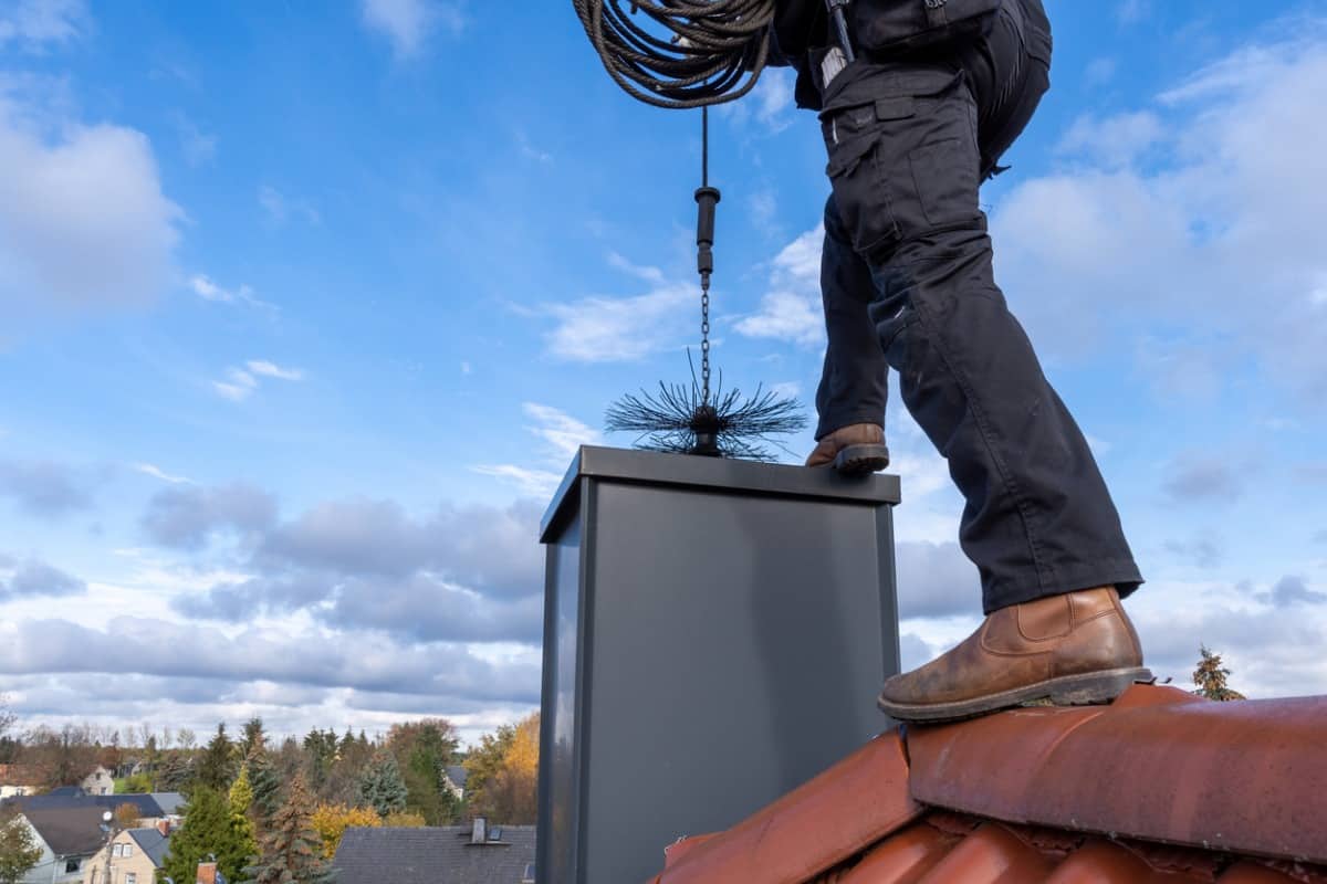 Technician inspecting roof ventilation system for proper airflow and safety.