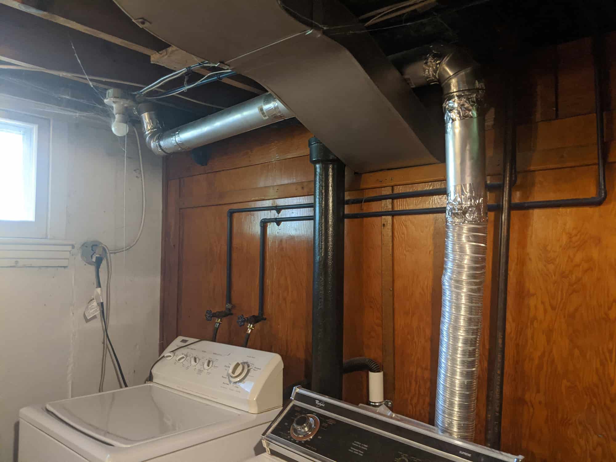 Newly rerouted dryer vent pipes in basement for improved airflow.
