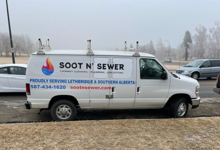 Soot N' Sewer service van parked on roadside with company info and logo.
