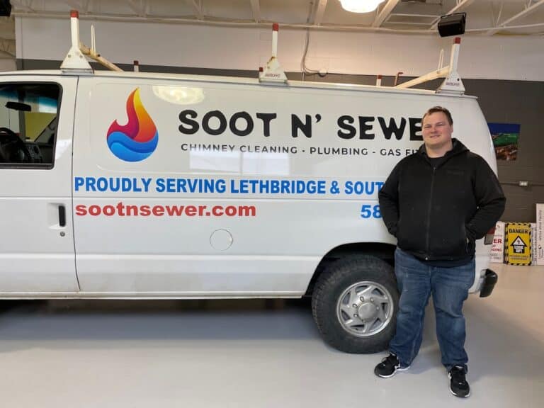 Service van for Soot N' Sewer with company logo and contact info.