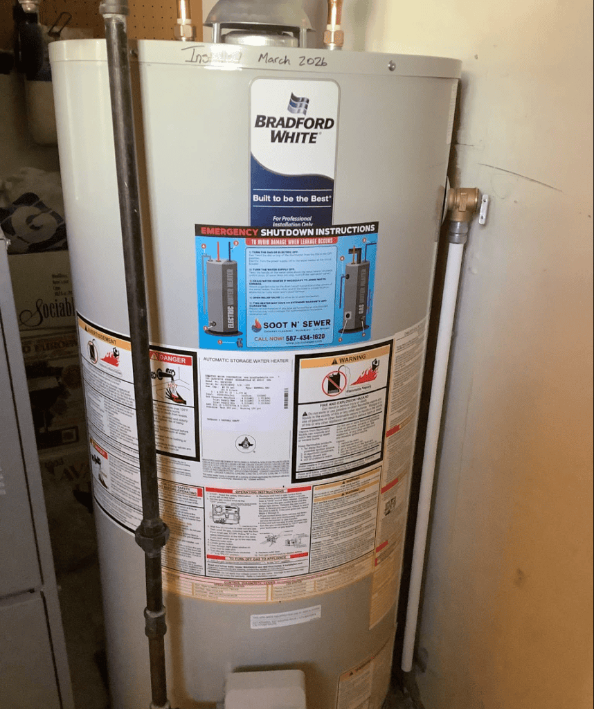 Bradford White hot water tank with safety and emergency instructions visible.