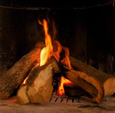A warm fire in a chimney. Burning wood in the fireplace and the flames