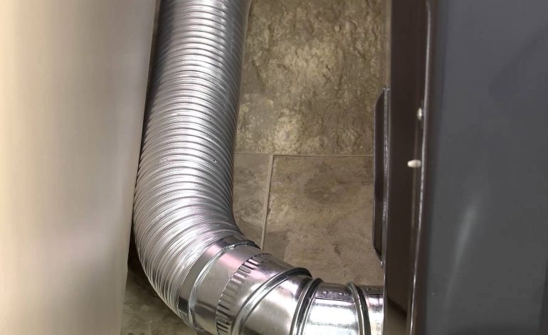 Flexible dryer vent hose connected to the dryer and wall vent.