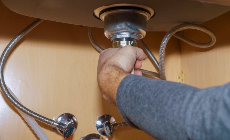Plumber Install a Sink In kitchen of plumber repairing drain
