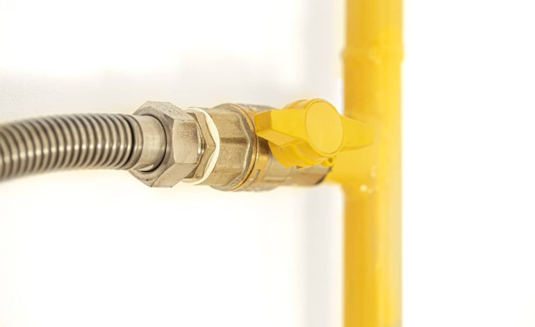 Yellow gas pipe with a valve. White background.